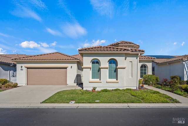 mediterranean / spanish-style home featuring stucco siding, a tile roof, roof mounted solar panels, concrete driveway, and an attached garage