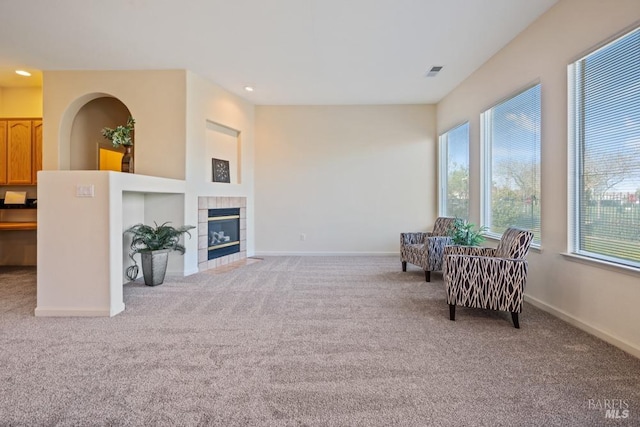 sitting room with baseboards, recessed lighting, a fireplace, visible vents, and carpet