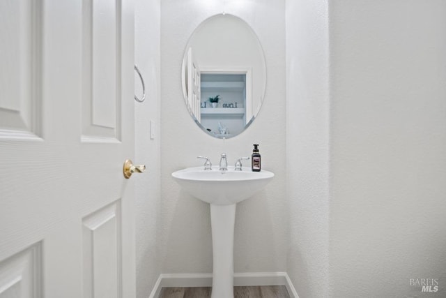 bathroom featuring baseboards and wood finished floors