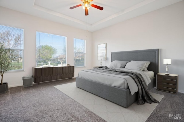 bedroom with carpet floors, baseboards, multiple windows, and a ceiling fan
