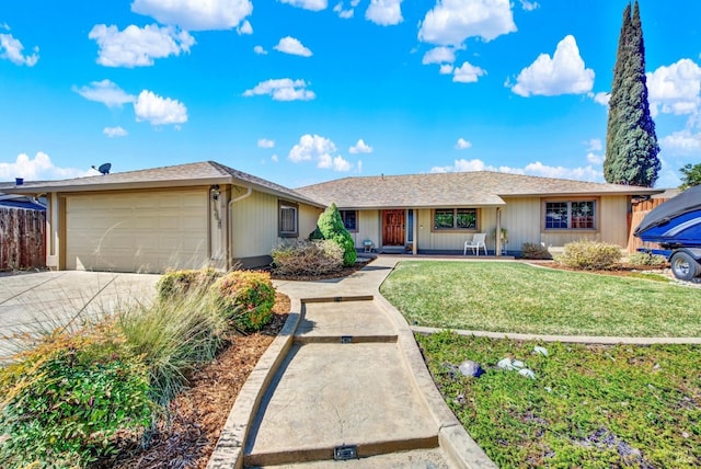 ranch-style home with a front lawn, fence, concrete driveway, covered porch, and a garage