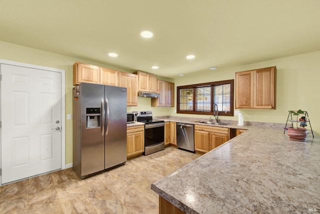 kitchen with light brown cabinets, under cabinet range hood, recessed lighting, appliances with stainless steel finishes, and a sink