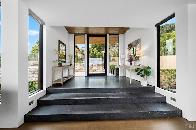 stairway with plenty of natural light and a wall of windows