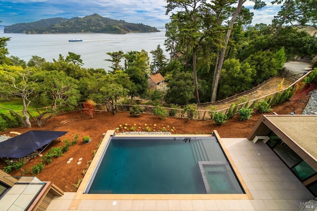 view of swimming pool featuring a water view and fence