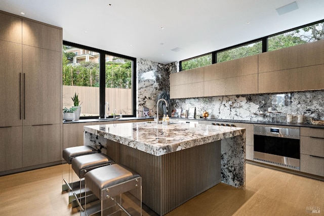 kitchen featuring light wood-style flooring and modern cabinets