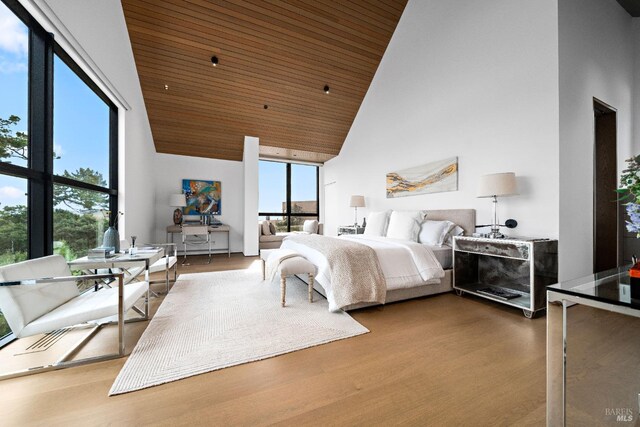 bedroom featuring wood ceiling, floor to ceiling windows, high vaulted ceiling, and wood finished floors