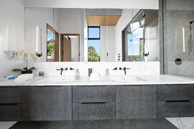 full bathroom featuring double vanity, wood ceiling, walk in shower, and a sink