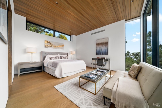 bedroom with wooden ceiling, floor to ceiling windows, wood finished floors, and visible vents