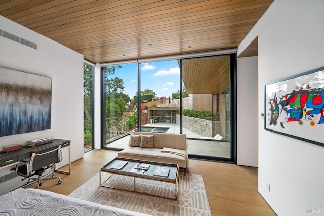 interior space with expansive windows, visible vents, wood finished floors, and wooden ceiling