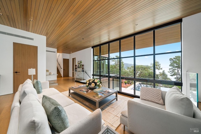 living room with wooden ceiling, stairs, a wall of windows, and wood finished floors