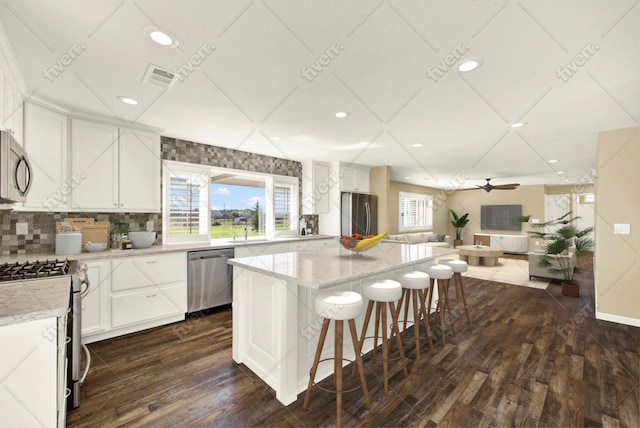 9862 Whalen Rd, Wallace, CA 95252 - kitchen featuring appliances with stainless steel finishes, recessed lighting, a breakfast bar area, dark wood-style floors, and a center island