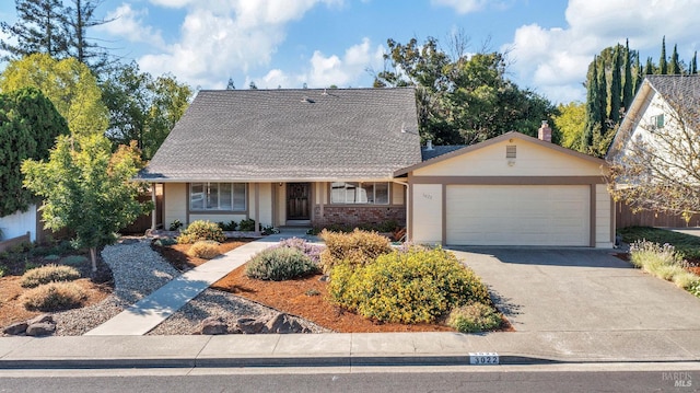 view of front facade with brick siding, concrete driveway, and an attached garage