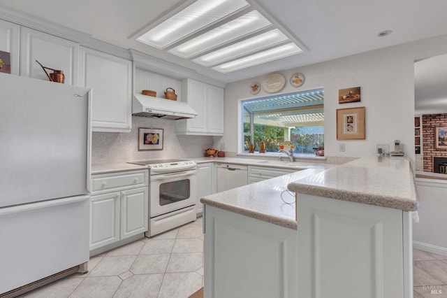 kitchen featuring under cabinet range hood, open shelves, white cabinetry, white appliances, and a peninsula