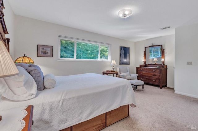 carpeted bedroom featuring baseboards and visible vents