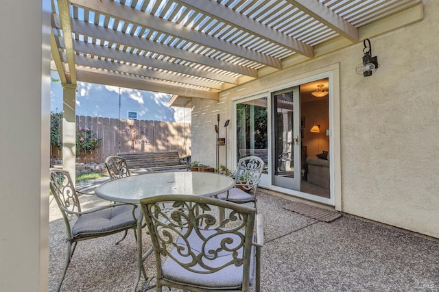 view of patio / terrace with outdoor dining area, fence, and a pergola