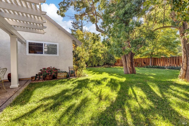 view of yard with a pergola and fence