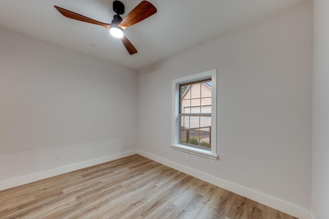 spare room with ceiling fan, baseboards, and wood finished floors