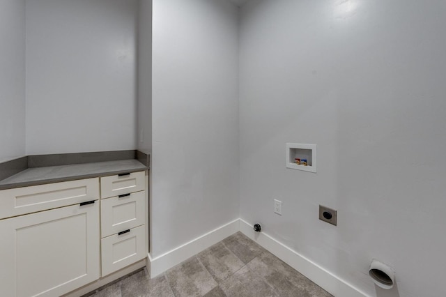 washroom featuring cabinet space, hookup for an electric dryer, baseboards, and washer hookup