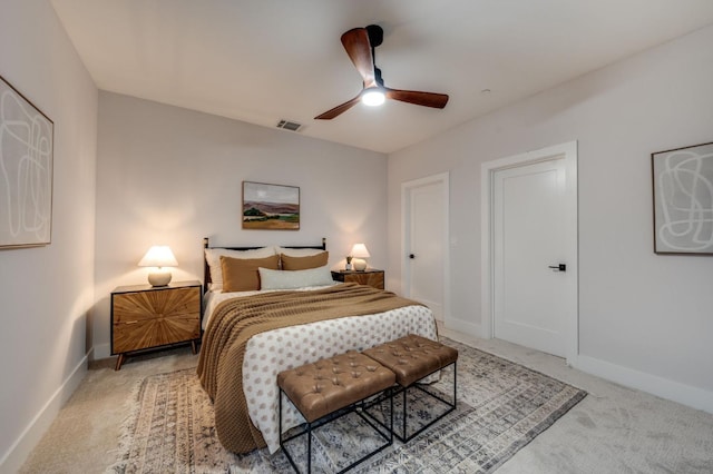 bedroom featuring visible vents, baseboards, light colored carpet, and ceiling fan