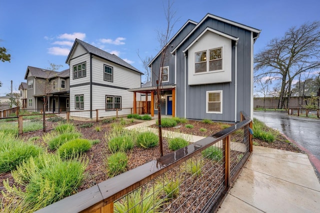 view of front of home featuring fence and board and batten siding