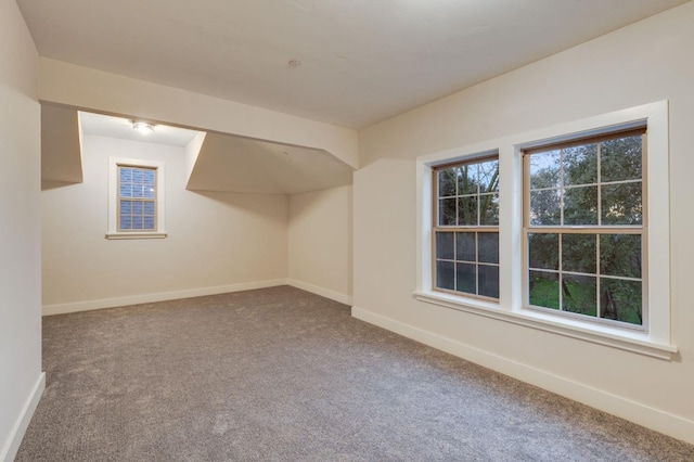 bonus room with carpet flooring and baseboards