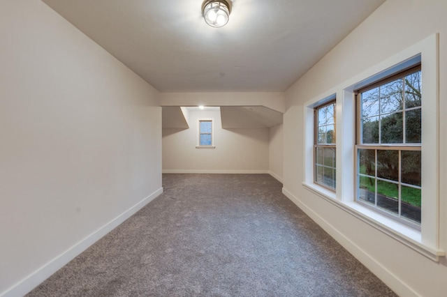 bonus room featuring baseboards and carpet floors