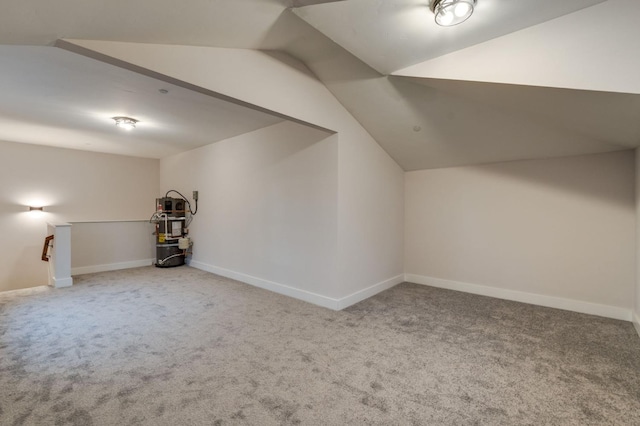 bonus room with baseboards, carpet, and vaulted ceiling