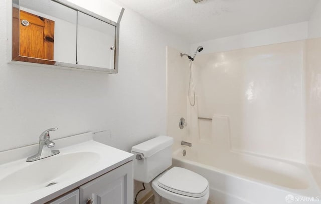 bathroom featuring toilet, vanity, and shower / bathing tub combination