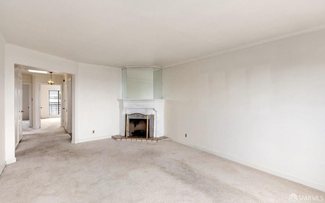 unfurnished living room featuring crown molding, a fireplace, baseboards, and light carpet