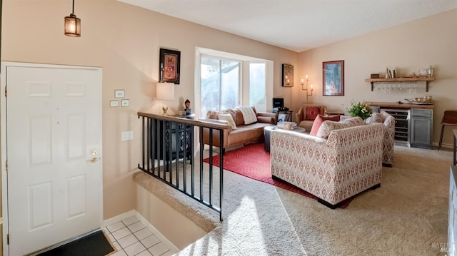 carpeted living room with baseboards, bar, and tile patterned flooring