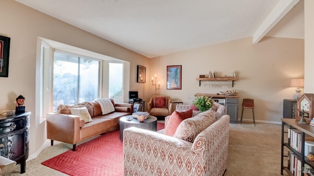 living room featuring light carpet, baseboards, vaulted ceiling with beams, and a bar