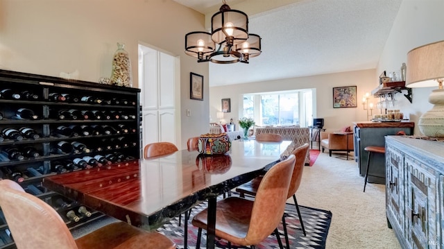 dining room with a textured ceiling, light carpet, a notable chandelier, and vaulted ceiling