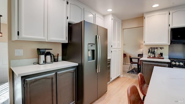 kitchen featuring white cabinetry, black appliances, recessed lighting, and light wood finished floors