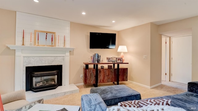 living area featuring a premium fireplace, recessed lighting, baseboards, and carpet floors