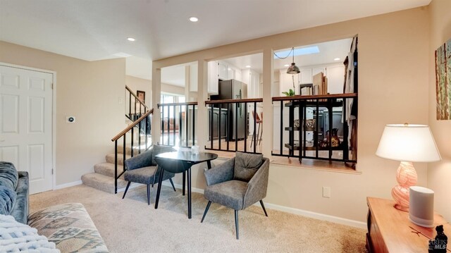 sitting room featuring stairs, baseboards, recessed lighting, and carpet flooring