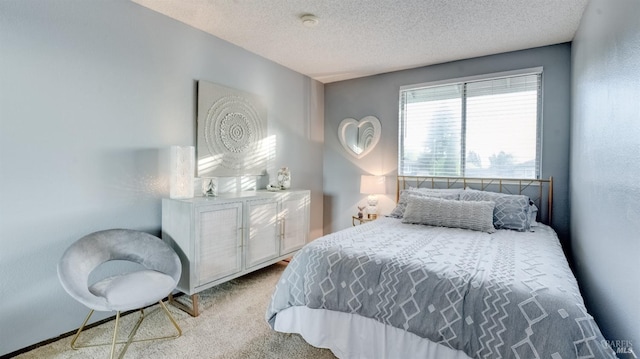 bedroom featuring carpet floors and a textured ceiling