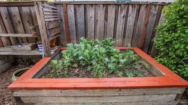 exterior details featuring a garden and fence