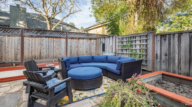 view of patio / terrace featuring an outdoor living space and a fenced backyard