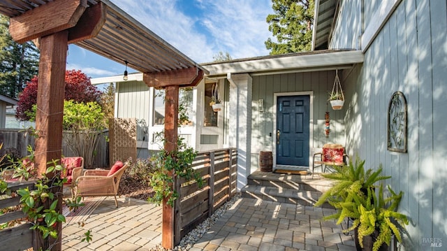 entrance to property featuring a patio area and fence