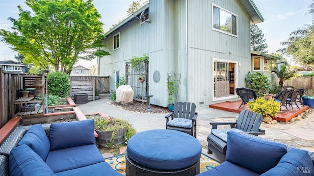 view of patio / terrace with outdoor lounge area, a deck, a fenced backyard, and grilling area