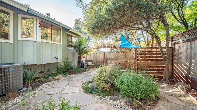 view of yard featuring central AC unit and a fenced backyard