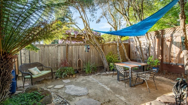 view of patio featuring a fenced backyard and outdoor dining space
