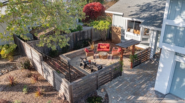view of patio with a garden, outdoor lounge area, and fence
