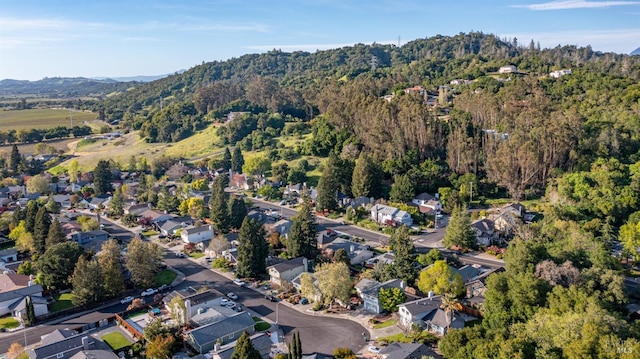bird's eye view with a mountain view, a view of trees, and a residential view