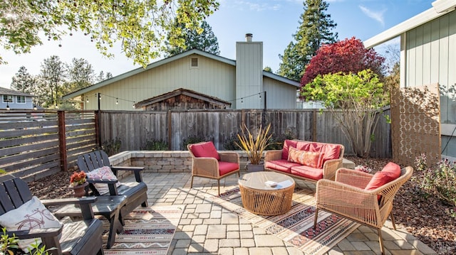 view of patio featuring an outdoor living space and a fenced backyard