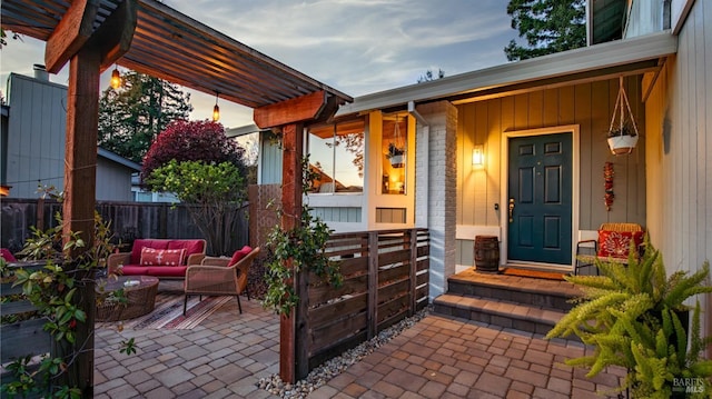 property entrance with outdoor lounge area, a patio, a porch, and fence