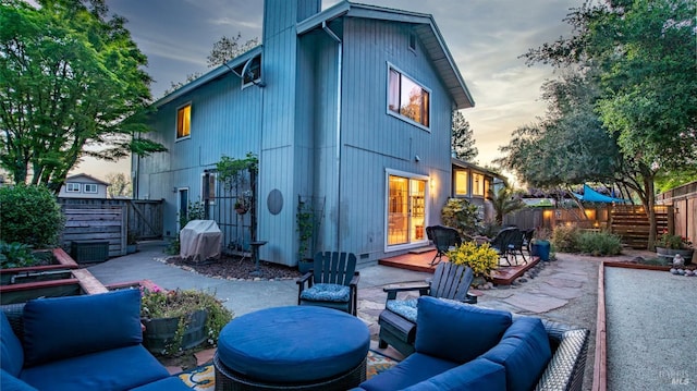 rear view of property with an outdoor hangout area, a patio, and fence