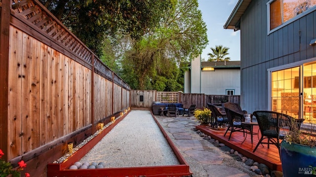 view of patio / terrace with a wooden deck and a fenced backyard