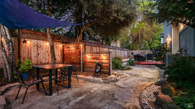 view of patio with outdoor dining space and a fenced backyard