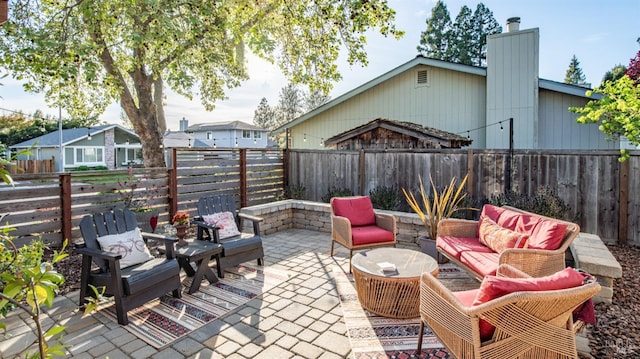 view of patio / terrace featuring an outdoor hangout area and a fenced backyard